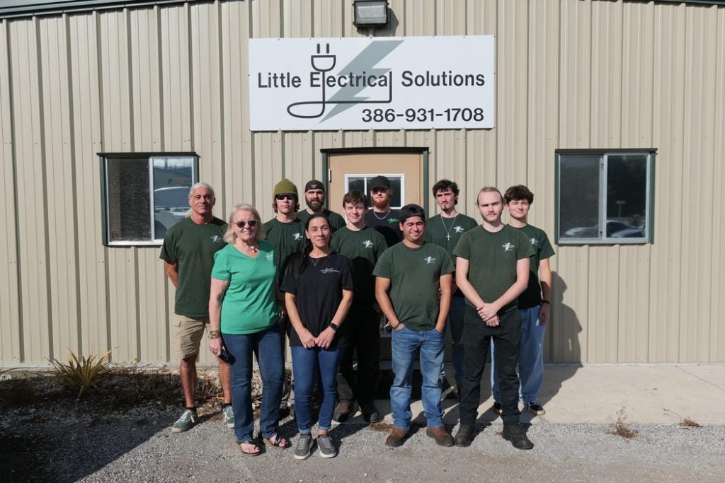 Little Electrical Solutions team of electricians standing in front of service vans in Palm Coast FL